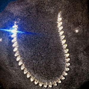 Silvertone tennis bracelet with rhinestones.